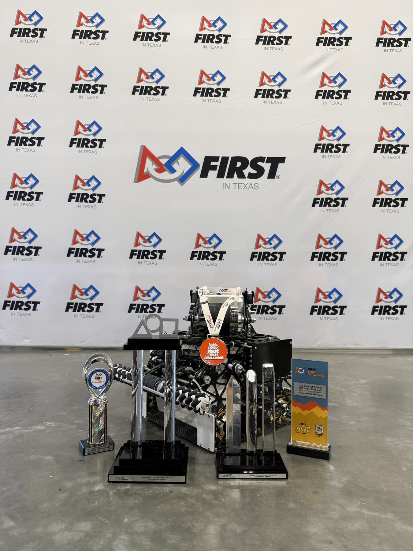 Competition robot with a row of FIRST trophies